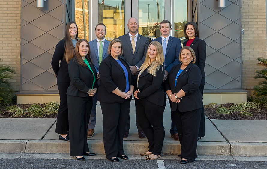 Group photo of 9 Southern First bankers outside the Summerville office.