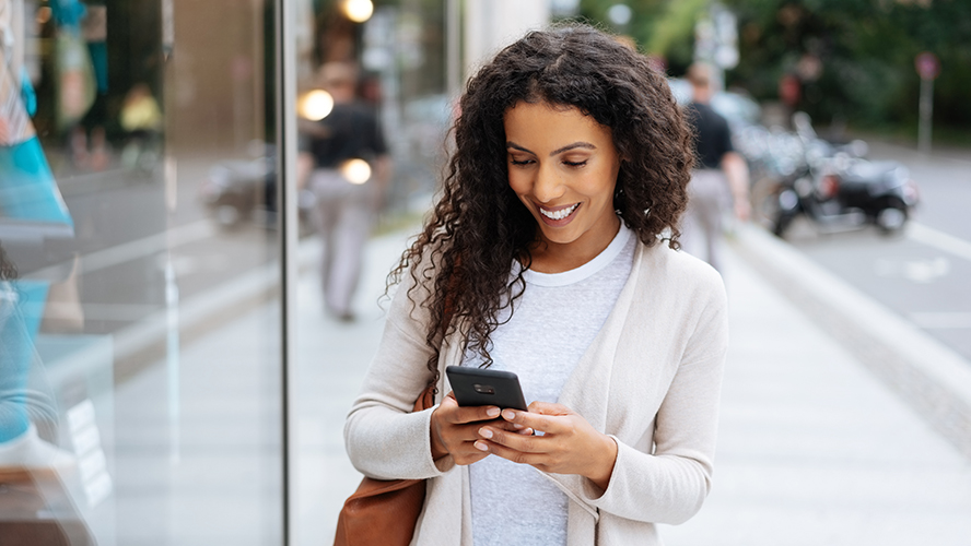 Woman looking at her phone and smiling.