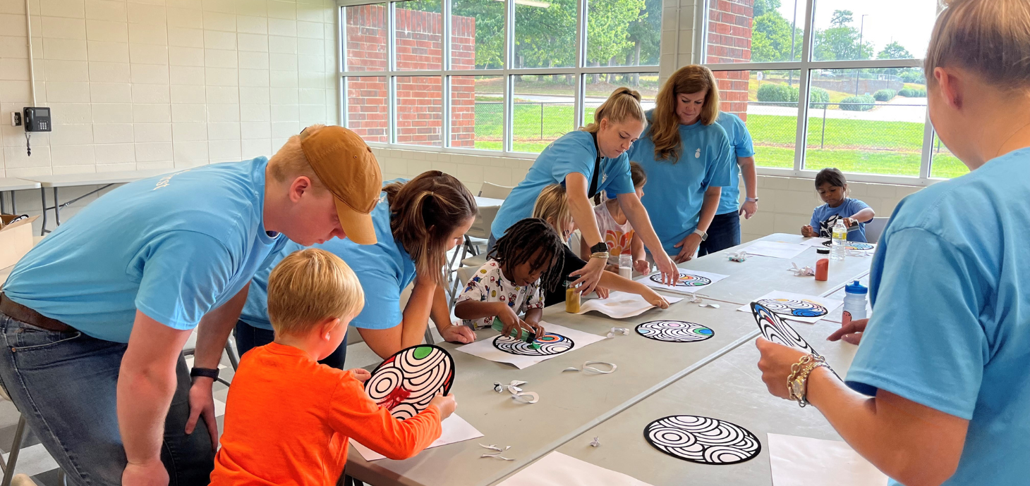 Southern First bankers doing a craft with children.