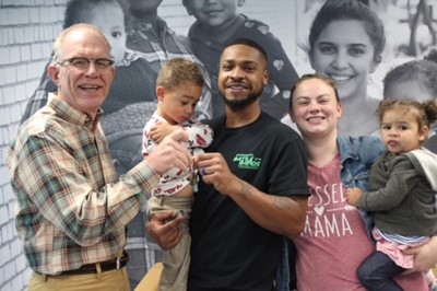 Andrew and Dena with their 2 kids and a Southern First banker.