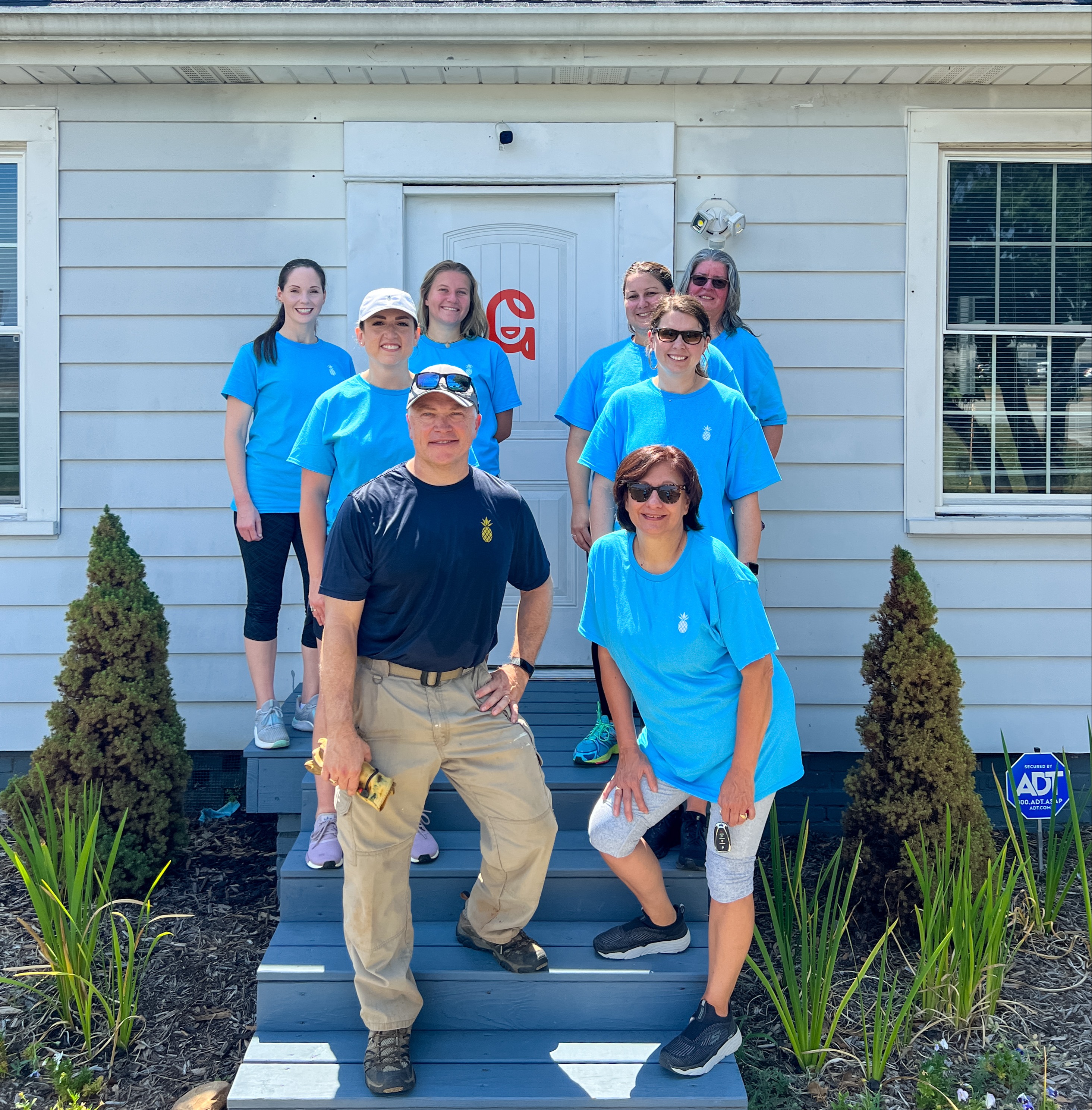 Southern First bankers in front of GirlUp GVL house.