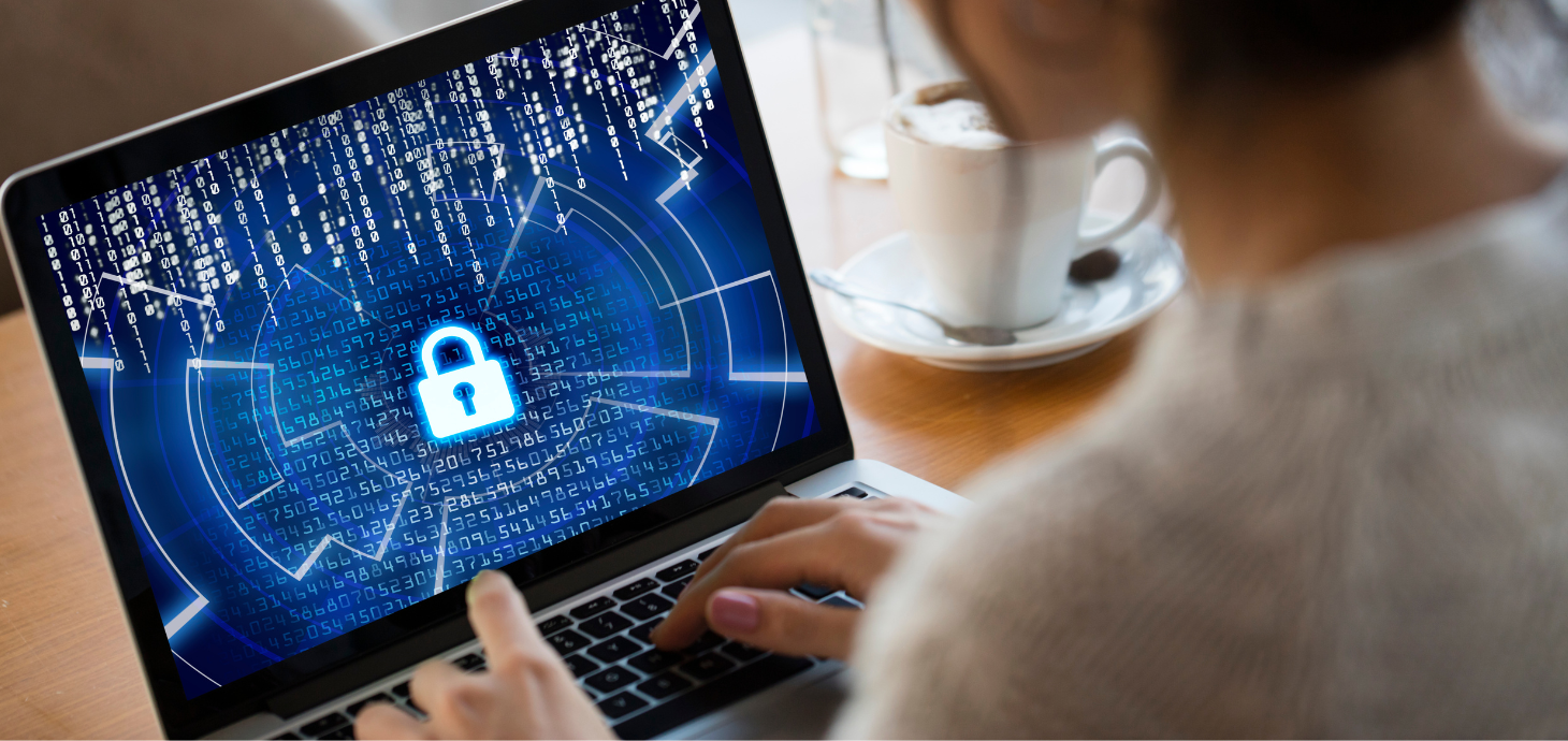 Hands typing on a laptop keyboard with graphics of security icons.