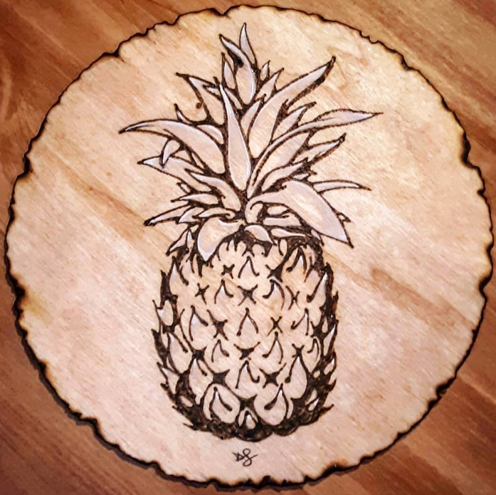 Pineapple woodburning art piece by Desiree Smith.